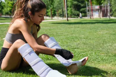 A girl is wearing shin guard for training